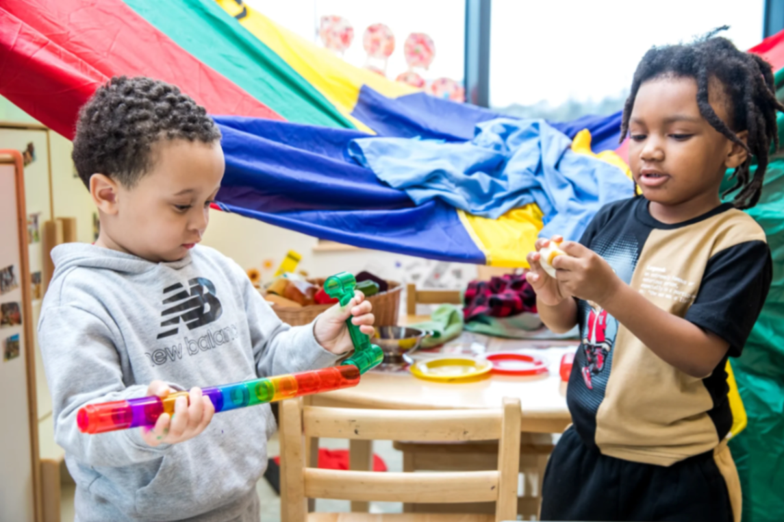 Two boys exploring colorful sensory toys at Horizons