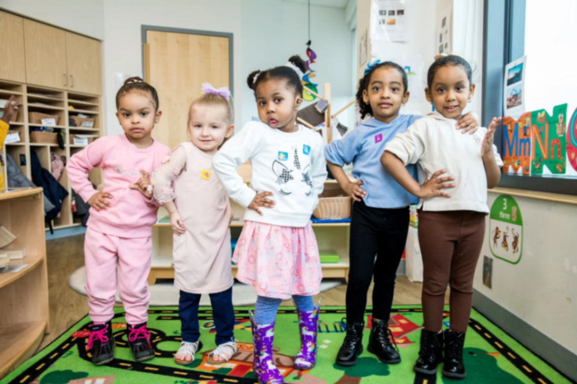 Group of preschoolers smiling together in a Horizons classroom